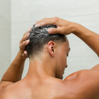 Man cleansing hair in shower