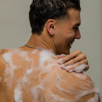 Man washing body with All Over in shower