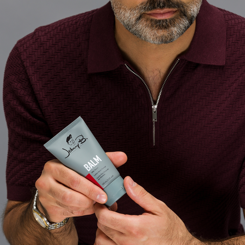 Man holding tube of Balm Aftershave