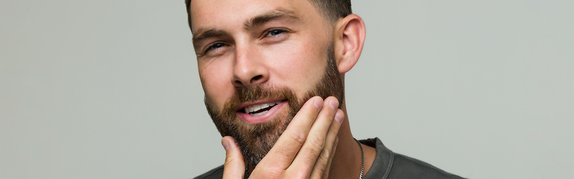 Man applying product into beard