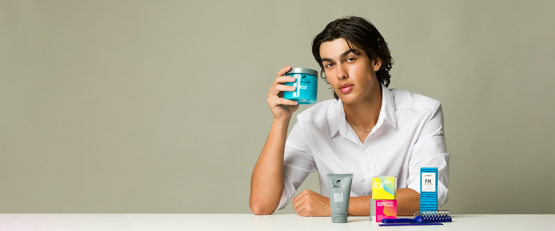 Man in front of various Johnny B. products