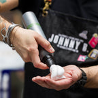 Barber spraying Foundation Mousse in palms of hands