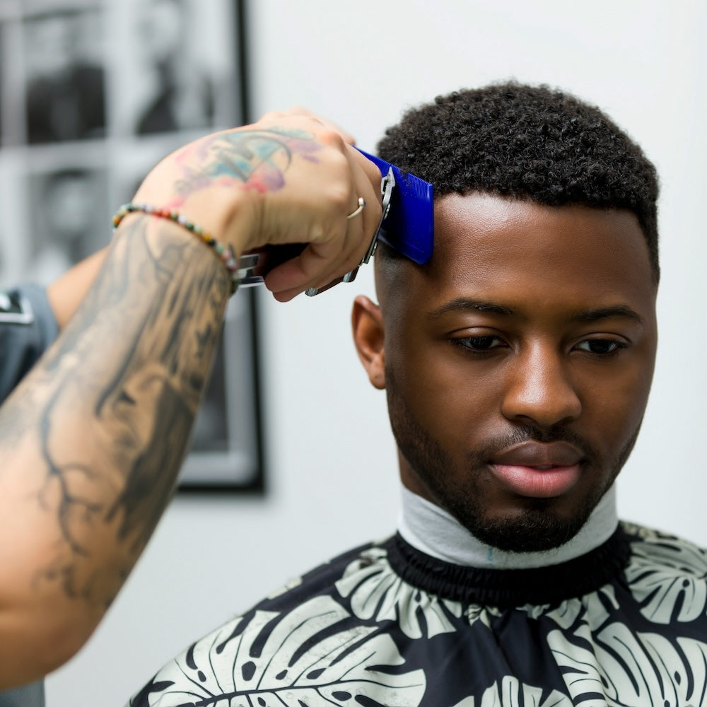 Barber cutting hair with Fade Comb