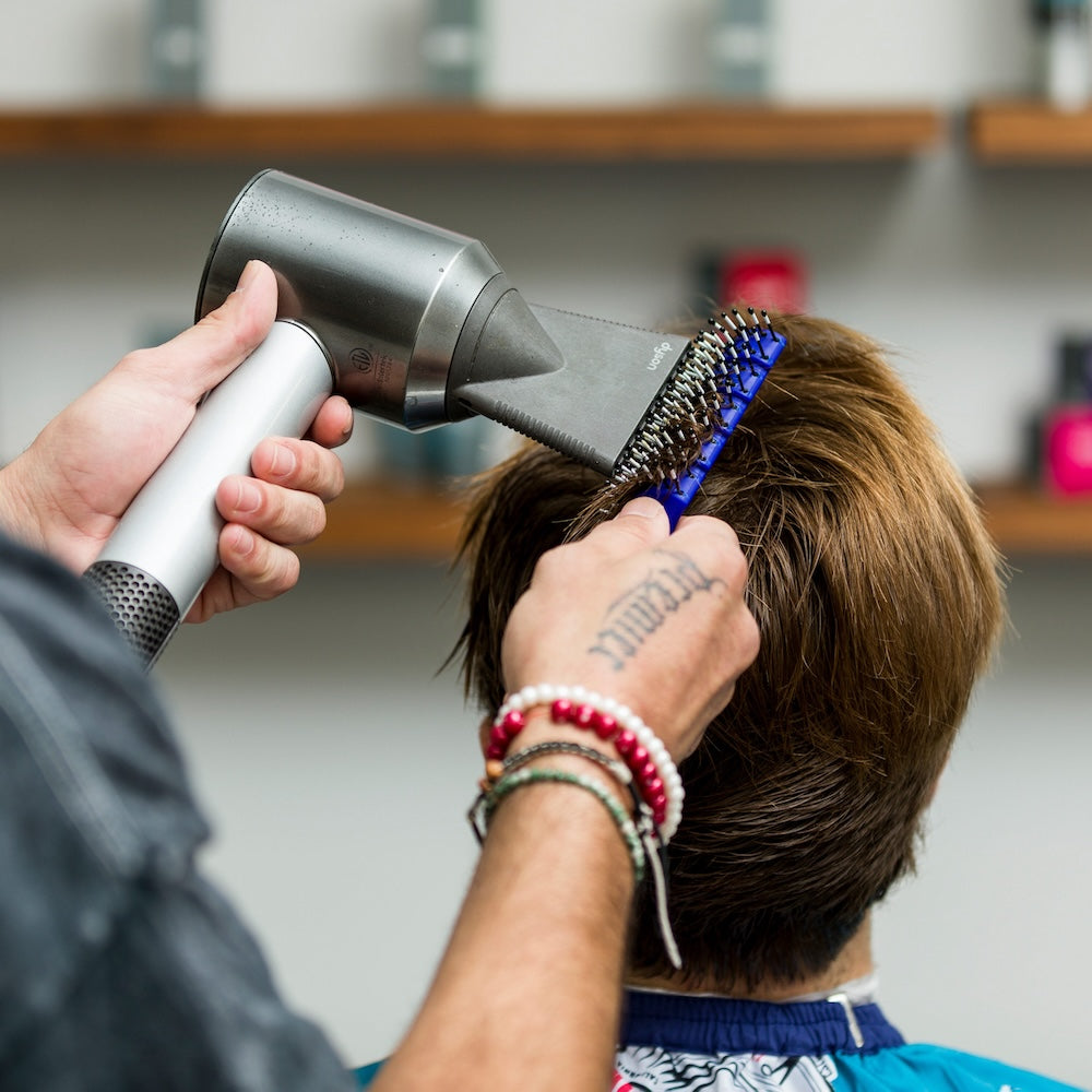 Barber brushing hair with Vent Brush