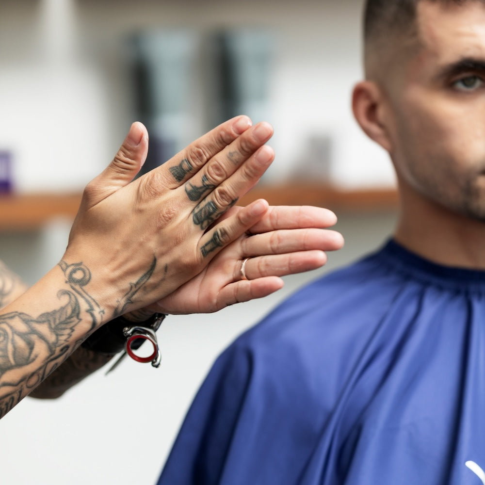 Barber applying pomade for styling