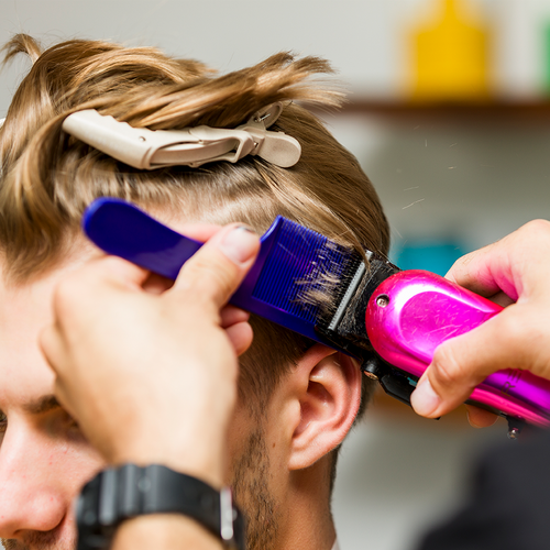 Barber cutting client's hair with Fade Comb