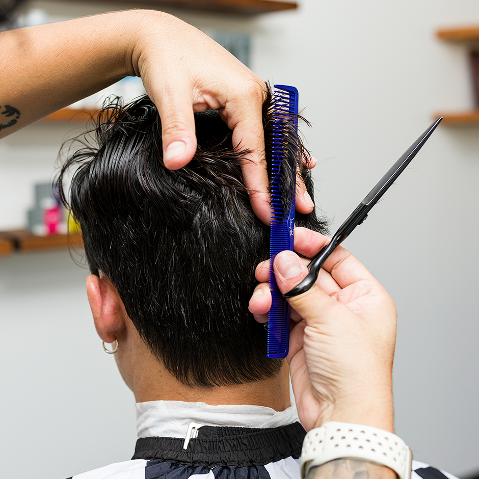 Barber cutting client's hair with Hair Cutting Comb