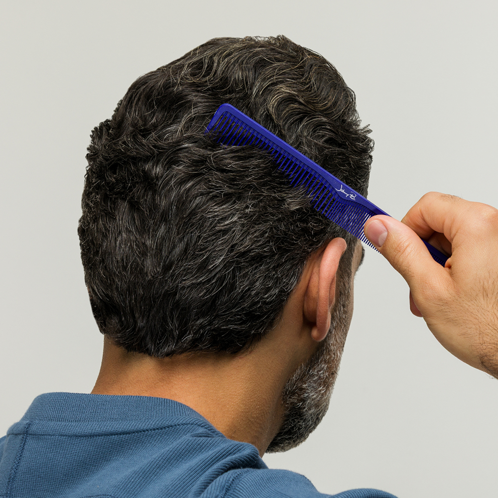 Man combing hair with Johnny B. blue comb