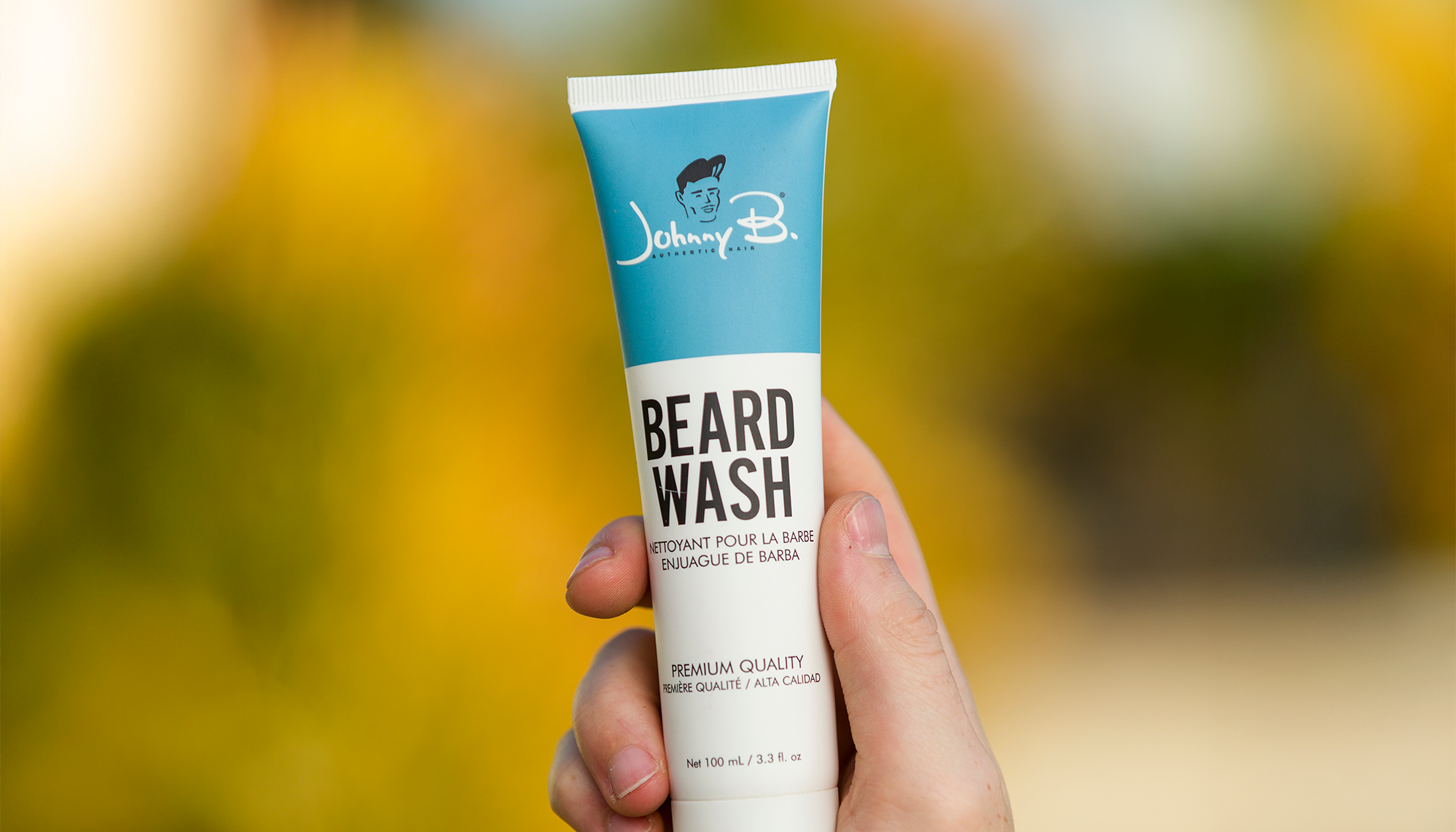 Someone holding tube of Beard Wash