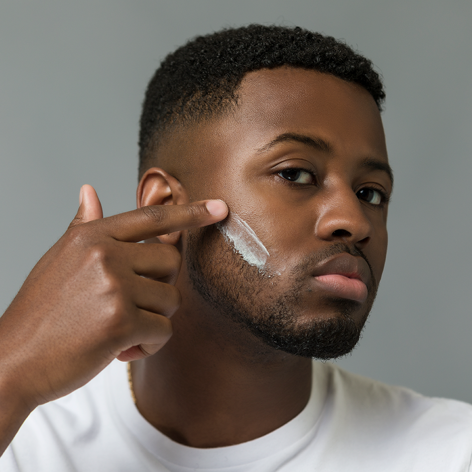 Man shaving beard with razor