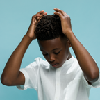 Child fixing hair and applying styling product