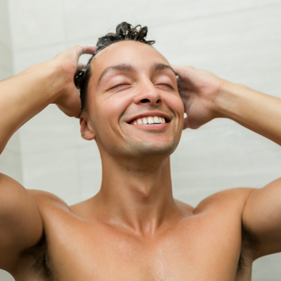 Man washing his hair in shower