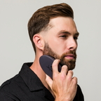 Man brushing beard with Beard Brush