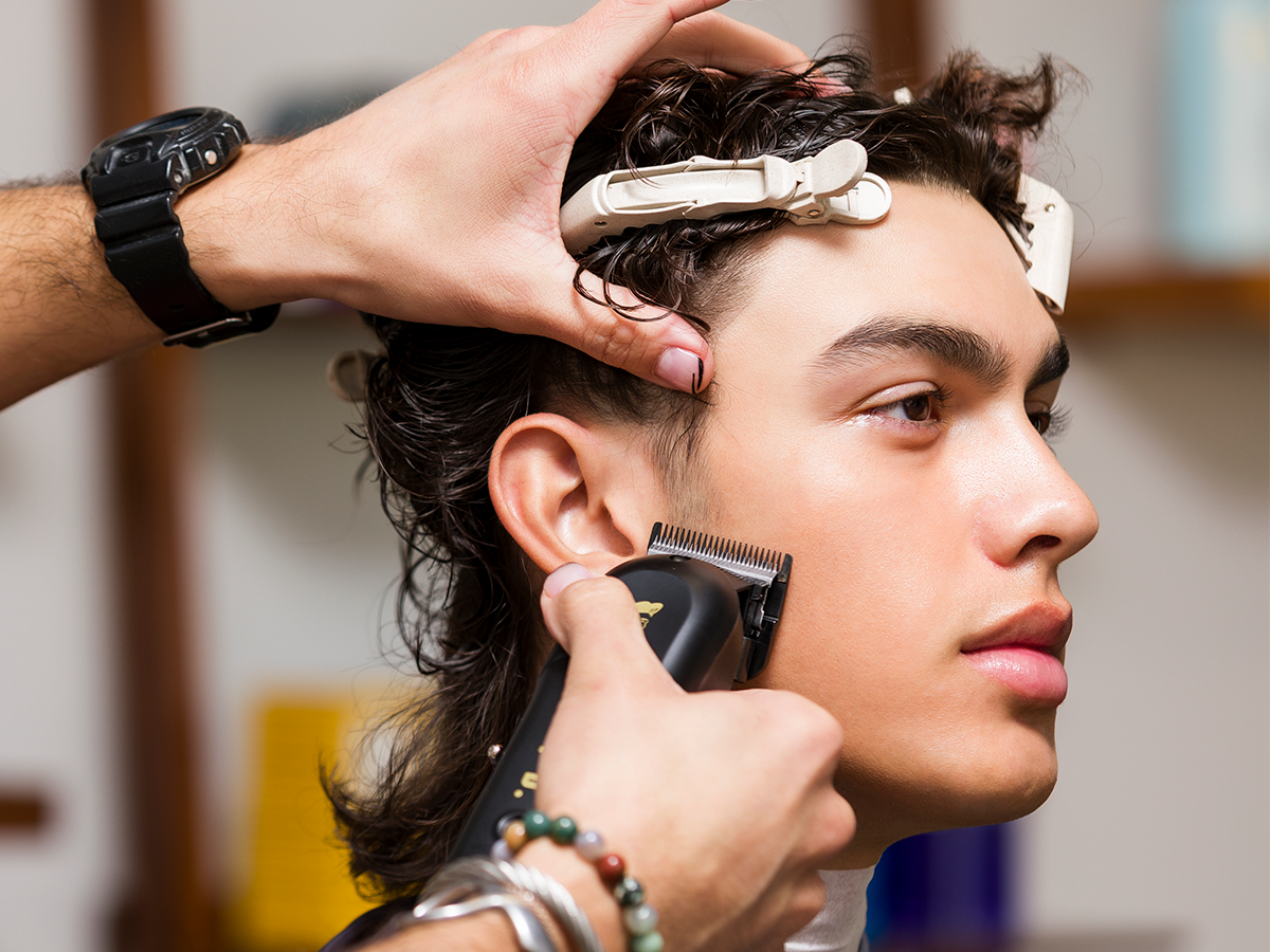 Barber trimming client's hair with Odyssey Clipper