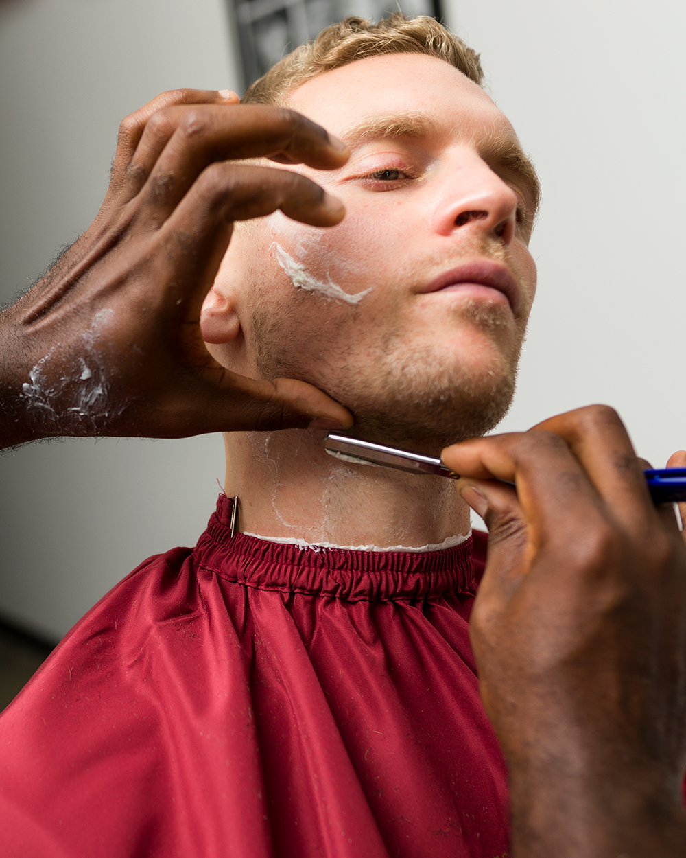 Barber shaving client's beard