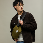 Man wearing a green move easy crossbody bag