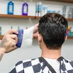 Barber dusting off client with Neck Duster
