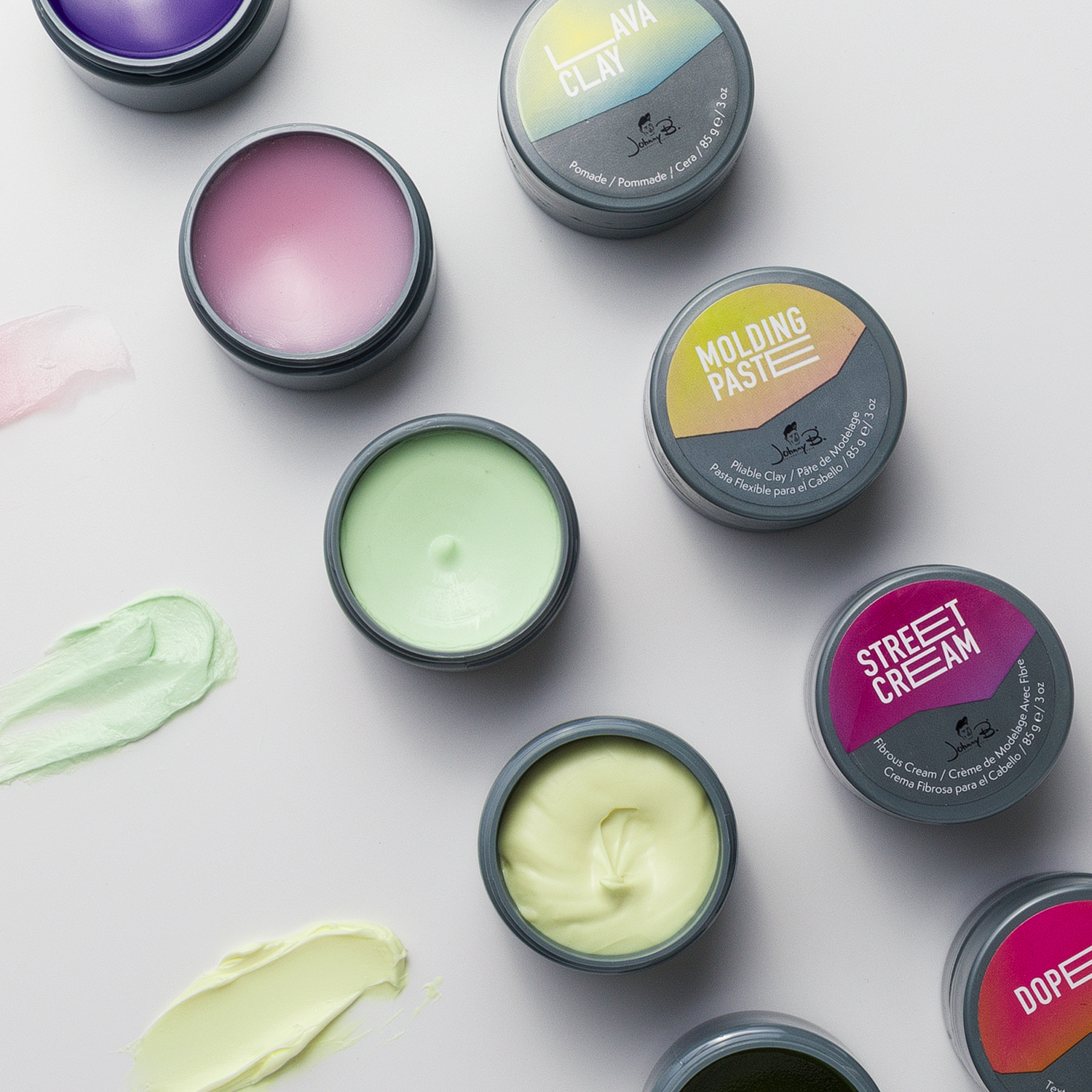 Pomades with lids open to showcase product
