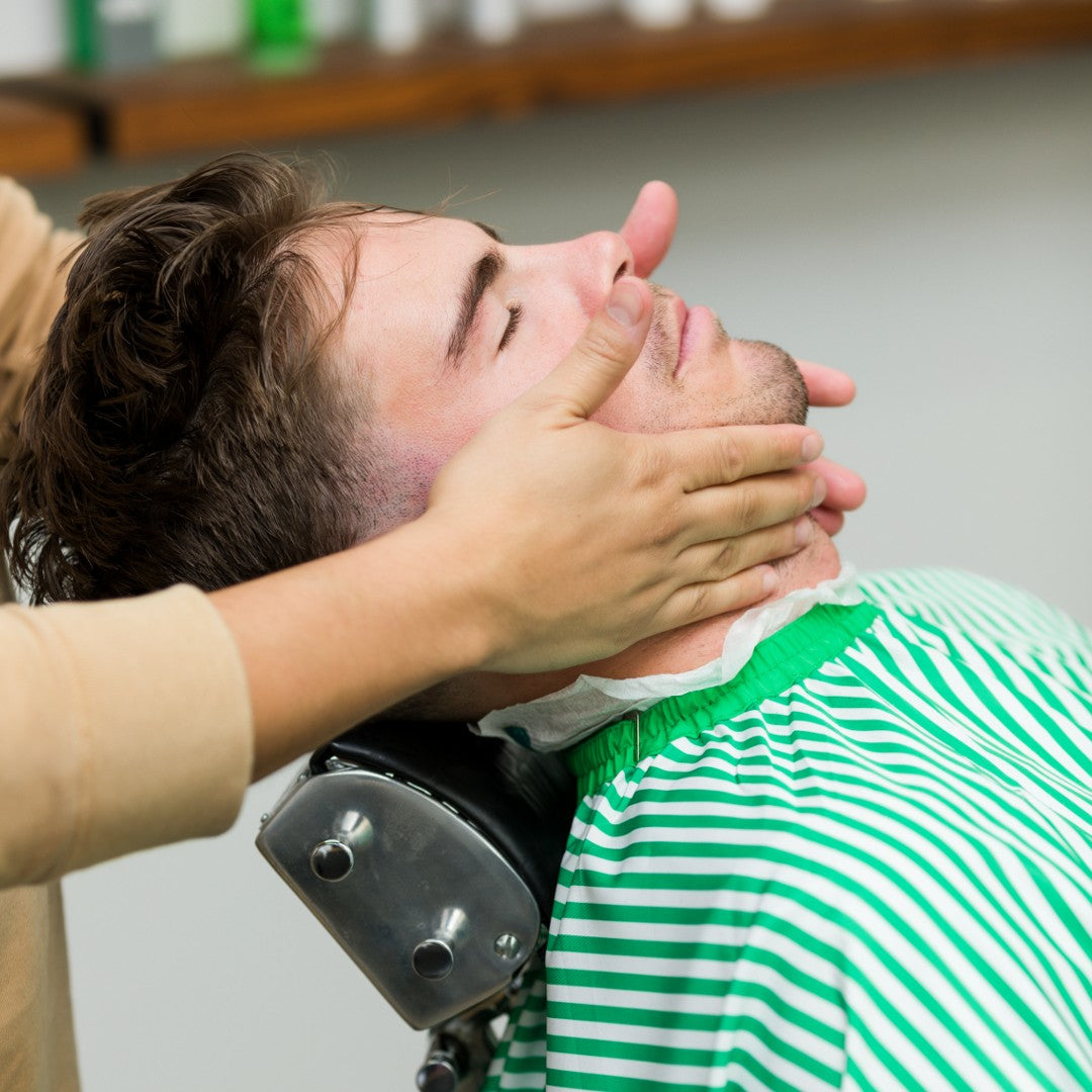 Barber applying Balm on client's skin