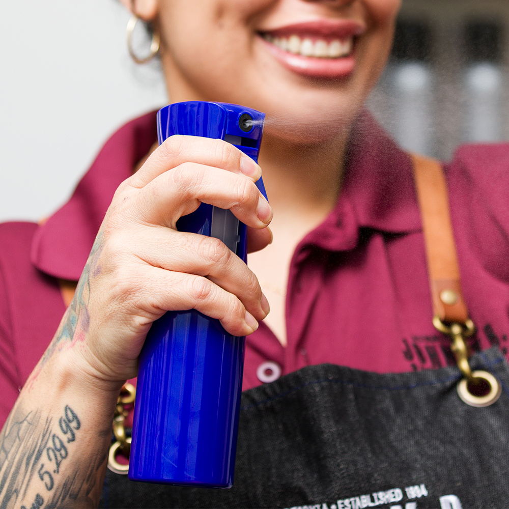 Barber using the Fine Mist Spray Bottle