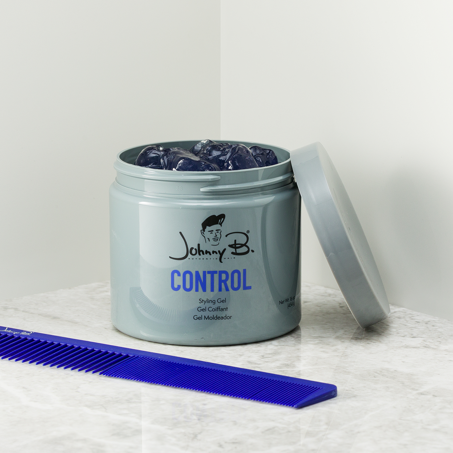 Jar of Control 16oz open, blue comb next to it
