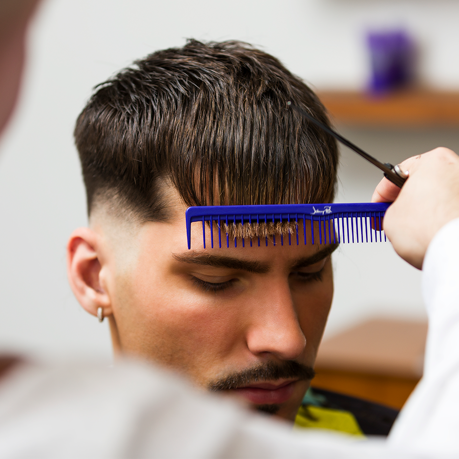 Barber cutting client's hair with Super Spreader Comb