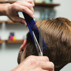 Barber cutting client's hair with Texturizing Comb
