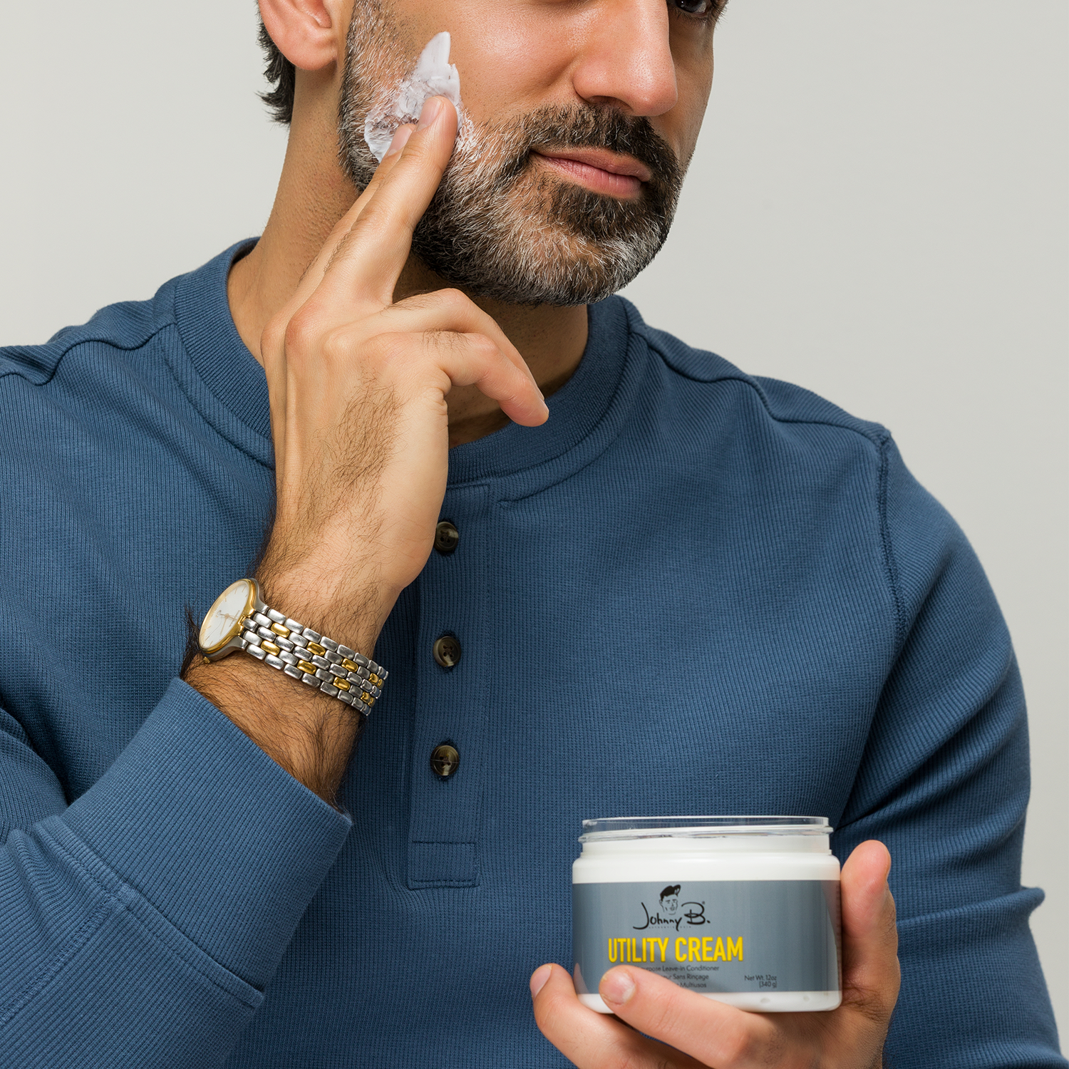 Man applying Utility Cream to his face and beard