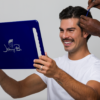 Man using blue mirror to check hair