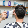 Barber using Neck Duster on customer