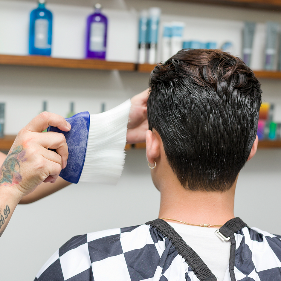 Barber using Neck Duster on customer