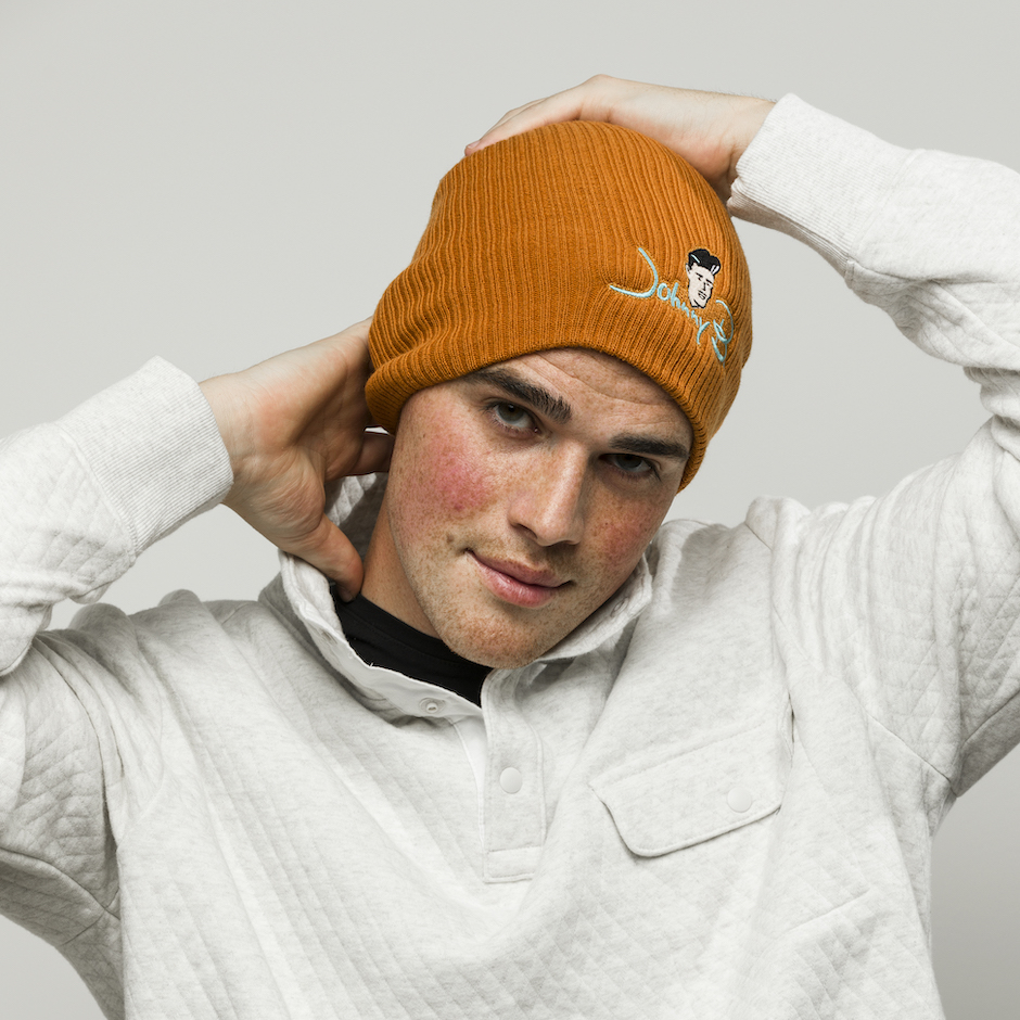 Model wearing orange Johnny B. beanie