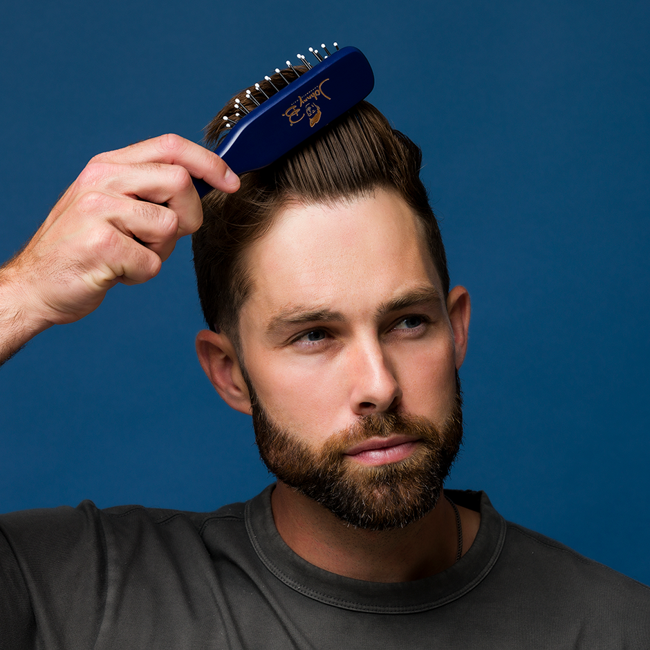 Model brushing hair with Boom Brush